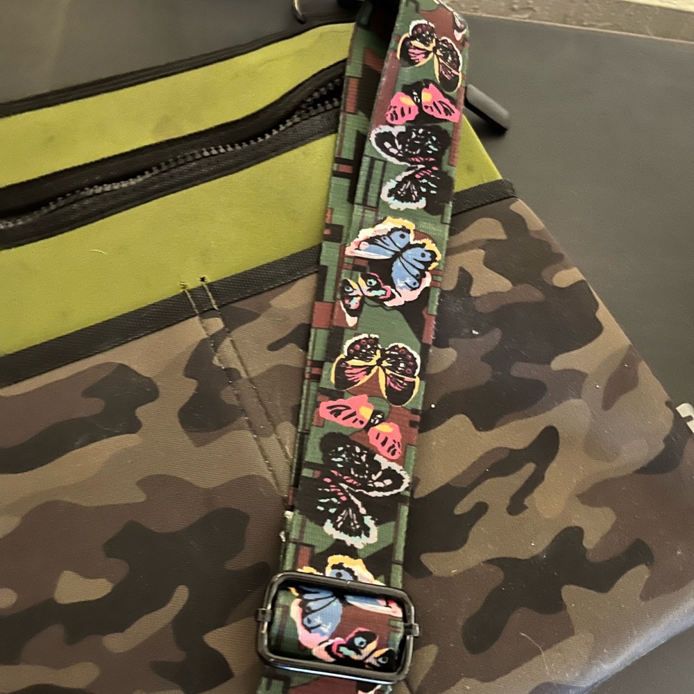 Crossbody bag, camo on one side, army green on back. Thick strap w butterflies.